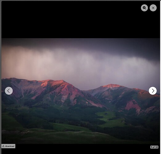 The image depicts a mountainous landscape during sunset, with clouds overhead casting light onto the mountain tops. (Captioned by AI)